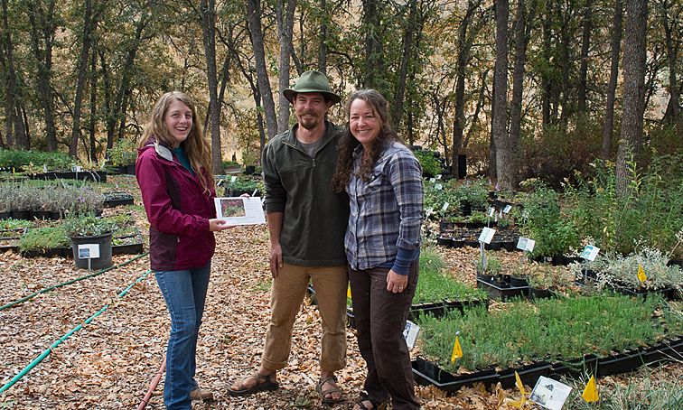 Emily presents the Nature Space Award to Kristin and Drew of Humble Roots