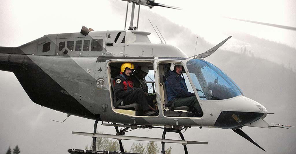 Guys in a helicopter on a cloudy day