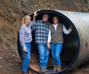 It cost East Fork Irrigation District $12 million to pipe 5.1 miles of their Central Canal. Standing in the 6 foot pipe from left Sharon Swyers, Mick Swyers, Cindy Sheppard. 