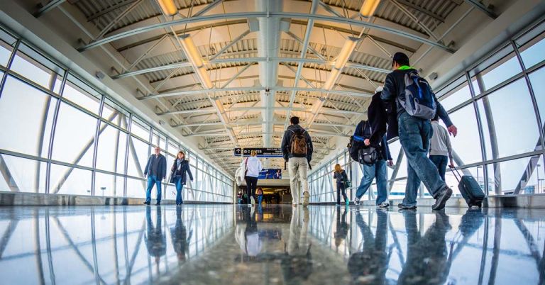 Travelers walking through airport terminal