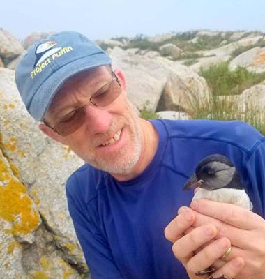 Don Lyons with a puffin chick