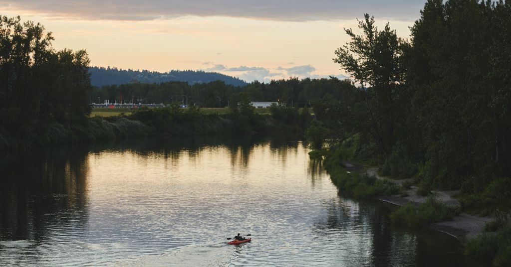 A kayaker near the mouth of the Sandy River, to the right is the Sandy River Delta. June 7, 2021