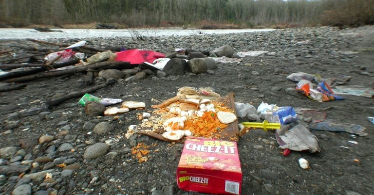 Trash along a scenic river scene