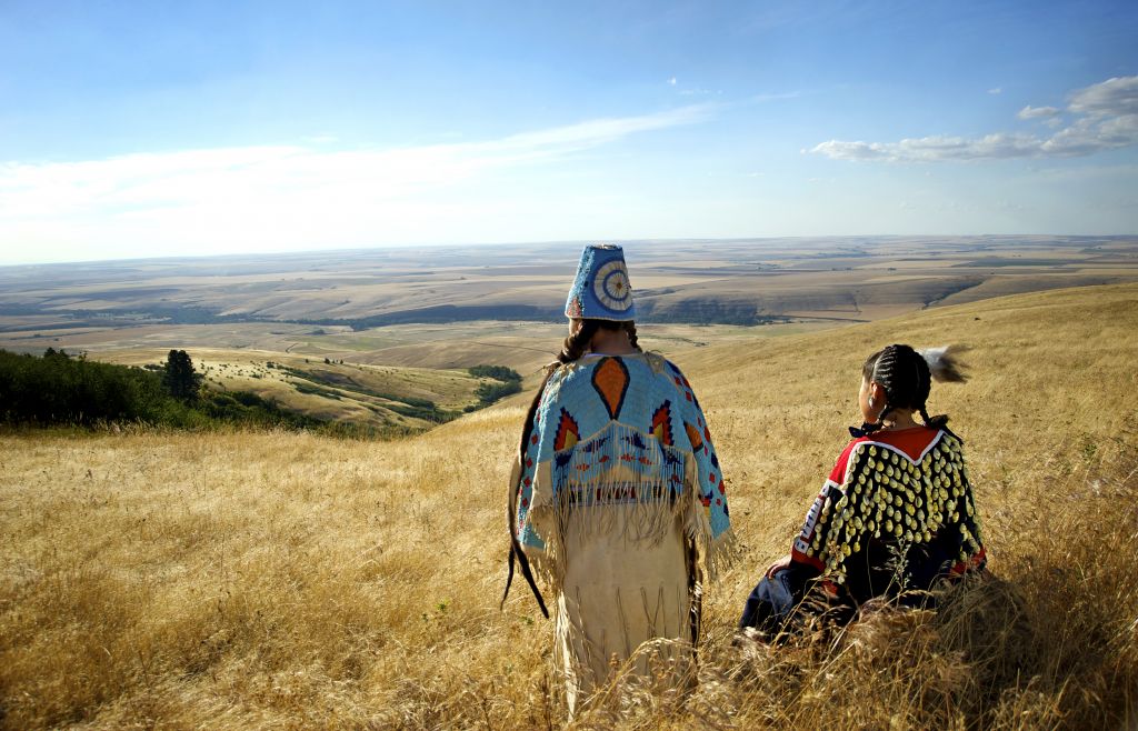 Girls in Umatilla beaded regalia of them looking west. Photo by Walters Photographers